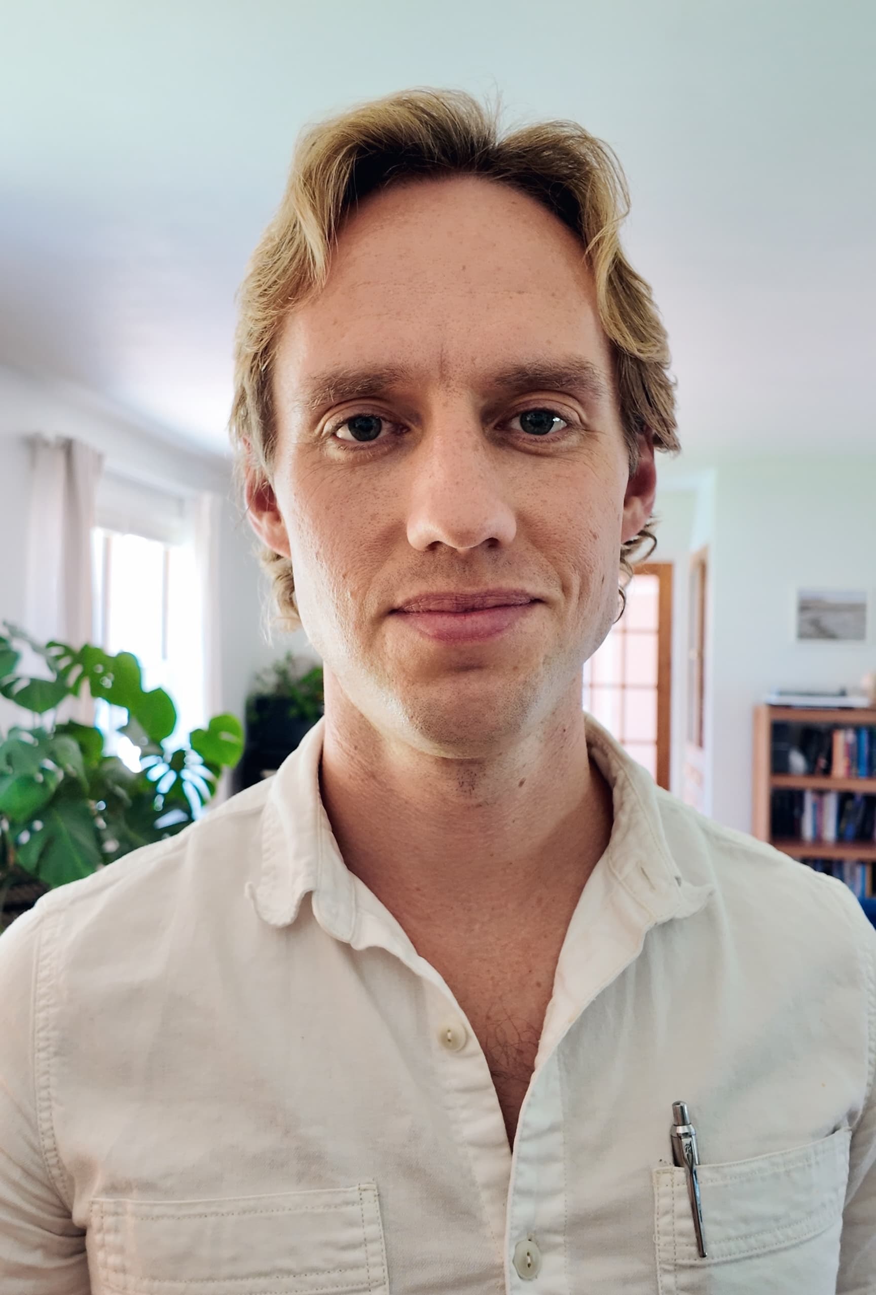 A headshot of Cameron in a yellow shirt